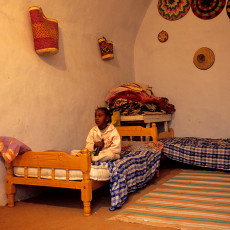 Girl watching sattelite TV, Nubian village